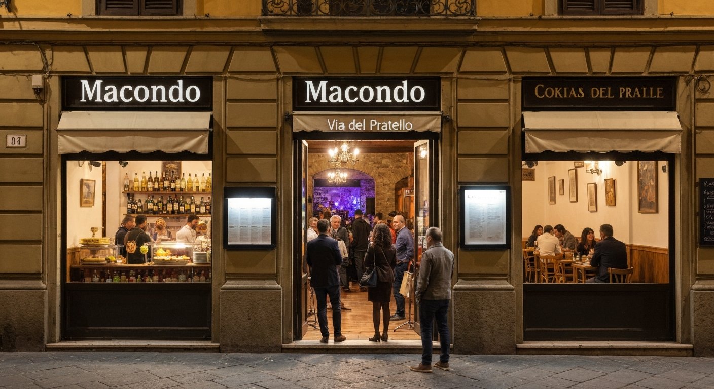 fasaden til Macondo på Via del Pratello om natten, aperitivo-buffet gløder inne mens en liten folkemengde lener seg i døråpningen med livemusikk som strømmer fra bakrommet
